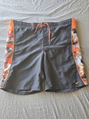 Nike Men’s Black Board Shorts with Orange Accents and Patterned Side Panels
